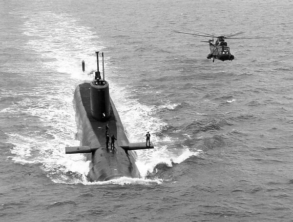 A Royal Navy Sea King alongside a submarine