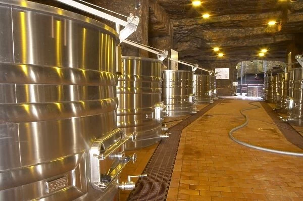 Cellar in an old stone quarry, modern stainless steel fermentation vats. Chateau Belair