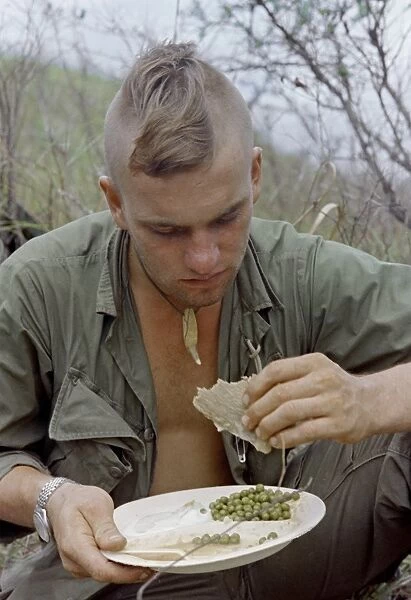 VIETNAM WAR, 1967. Specialist 4th Class Henry Greenwood eating a hot meal after Operation Cook
