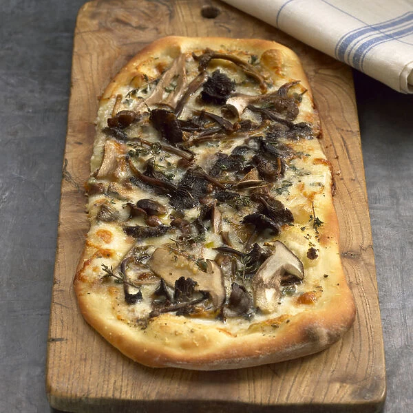 Wild mushroom pizza on chopping board