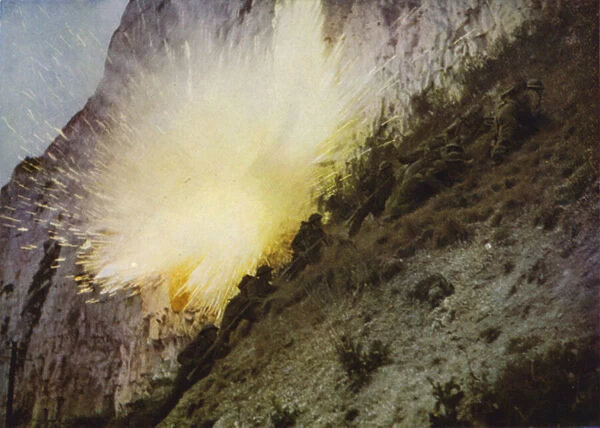 British Royal Marines in training, climbing a cliff while under fire from live ammunition and exploding ground charges, World War II, 1939-1945 (photo)