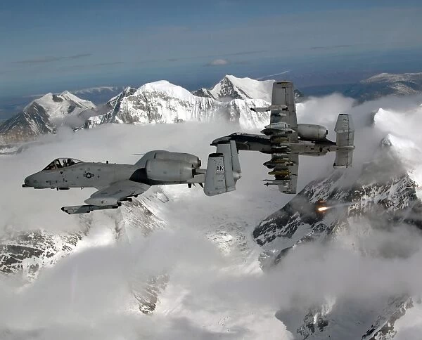 A-10 Thunderbolt IIs fly over mountainous landscape