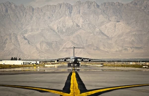 A C-17 Globemaster III taxis to its parking spot at Bagram Airfield