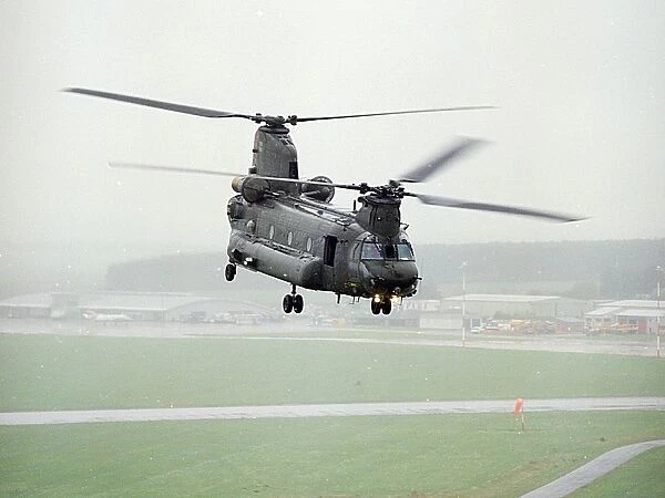 A Chinook of 27 Sqn based at RAF Odiham photographed flying low over an airfield in Scotland