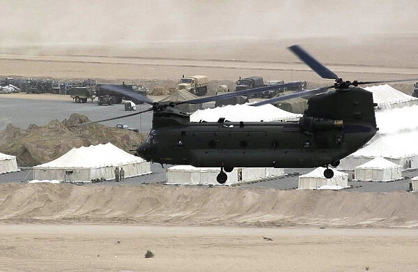 A Chinook helicopter from the Joint Helicopter Force, flying over the desert of the Middle East