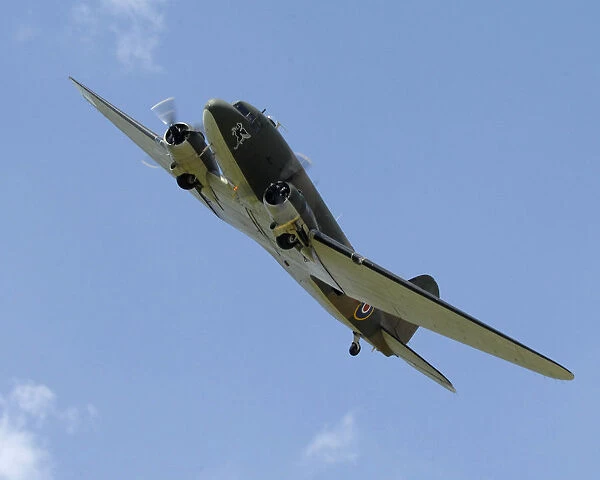 A Douglas C-47 Dakota of the Battle of Britain Memorial Flight, is shown flying in