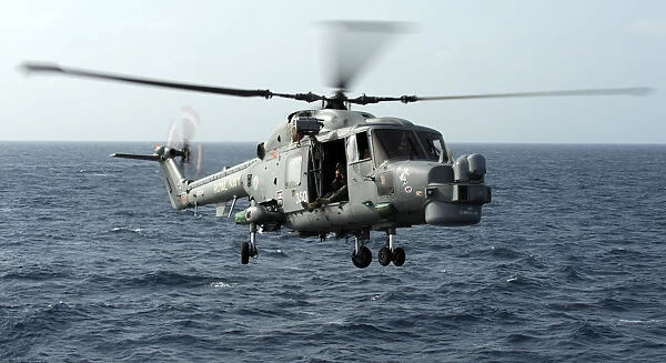 Helicopter Capturing Images Of A Lynx Landing On HMS Cornwall