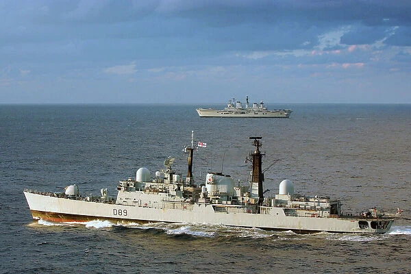 HMS Exeter is shown in the foreground with HMS Illustrious, taking part in Exercise Neptune Warrior