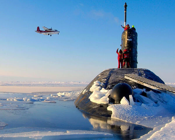 HMS Tireless is shown surfacing in the North Pole ice cap region