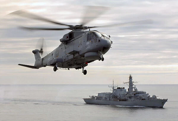 Merlin helicopter hovers over HMS Sutherland