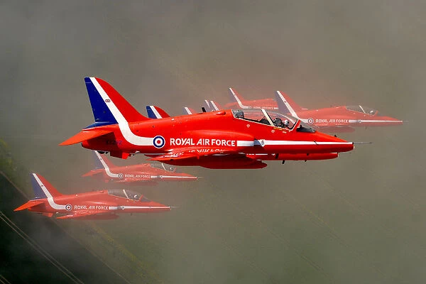 The Red Arrows fly through cloud in tight formation during display training