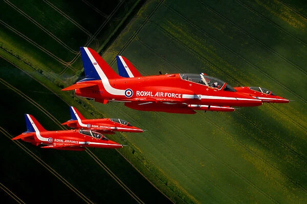 The Red Arrows roll upside down in tight formation during display training