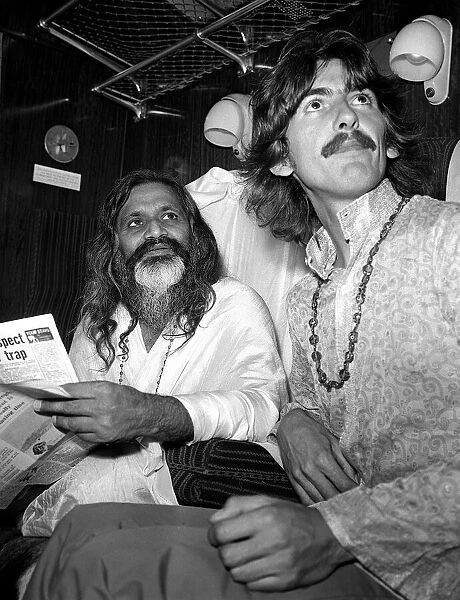Beatle George Harrison on the train going to Bangor in North Wales with Mahirishi Yogi