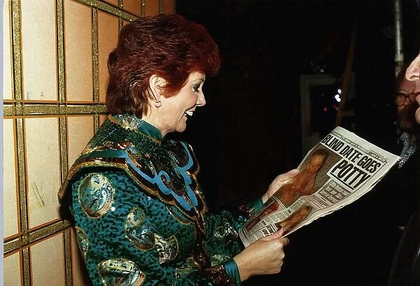 Cilla Black TV Personality reading Daily Mirror during Panto rehearsals at the Wimbledon