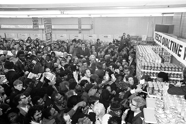 Muhammad Ali at a supermarket in Stretford to promote Ovaltine cornered by loads of fans