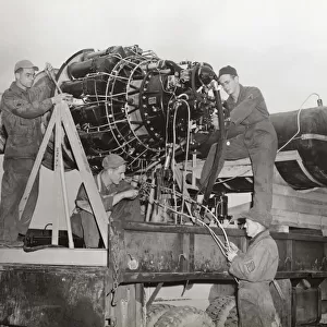 Airmen Working on a Jet Engine Mounted on a Special Fram?