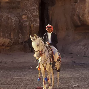 Arab man on grey Arabian horse