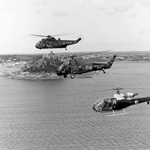 Three Royal Navy helicopters alongside St Michaels Mount