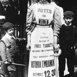 A suffragette advertising a votes for women march
