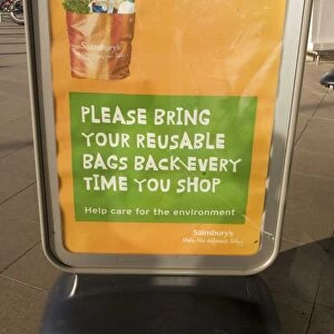 Poster encouraging reusable bags outside Sainsbury's Cheltenham UK