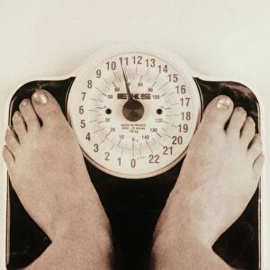 Womans feet on a set of weighing scales