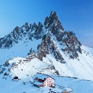 Dusk on Locatelli mountain hut with Paterno mountain in the background, winter view, Tre Cime di Lavaredo (Lavaredo peaks), Sesto (Sexten), Dolomites, South Tyrol, Italy, Europe