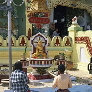 Two people praying at a pagoda, Yangon (Rangoon), Myanmar (Burma), Asia