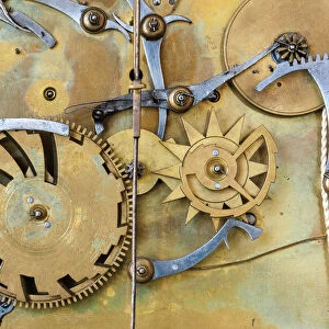 Gears and cogs in the clockwork of a historical pendulum clock, detail, regulator