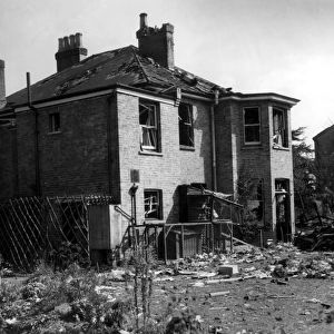 A house in the Bexley area, showing considerable damage, surrounded by debris after