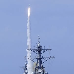The guided-missile destroyer USS Benfold fires a surface-to-air missile off the coast