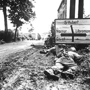 Infantrymen seek cover during a firefight in Libin, Belgium, during WWII