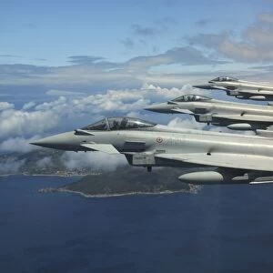 Three Italian Air Force EF2000 aircraft fly in formation over the Mediterranean