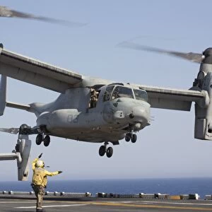 An MV-22 Osprey takes off from the amphibious assault ship USS Kearsarge
