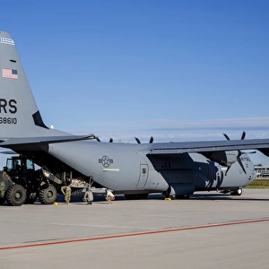 A U. S. Air Force C-130J Super Hercules is being unloaded