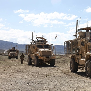 Three U. S. Army Mine Resistant Ambush Protected vehicles