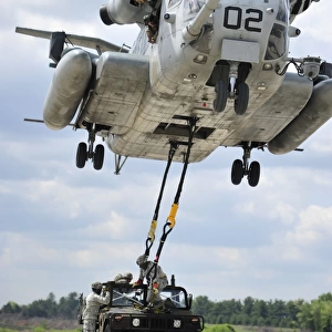 U. S. Marines conduct a sling load operation with a CH-53E Super Stallion