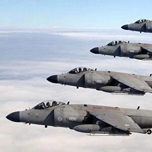 Four FA2 Sea Harriers, based at RNAS Yeovilton, flying in formation above the clouds