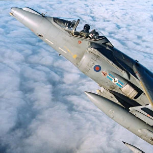 An RAF Harrier GR7 of 20 Squadron, based at RAF Wittering, is pictured flying above the clouds