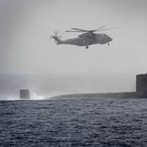 Royal Navy Submarine HMS Turbulent with a Merlin Helicopter from HMS St Albans
