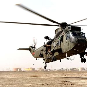 A Sea King Mk4 is shown landing at Basra Airport