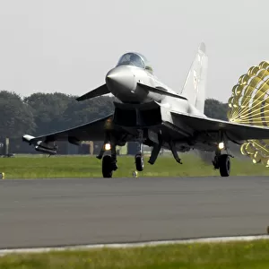 A Typhoon F2 fighter jet deploys a brake parachute as it lands at RAF Coningsby