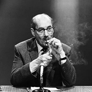 American comedy actor Groucho Marx smoking a cigar at a press conference in London