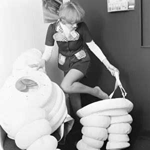 Model seen here putting on a Michelin man costume at the 1972 Motor Show at Earls Court