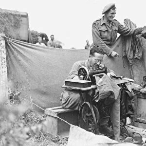 WW2 August 1944 Front line tailor and cobbler. Private Peter Barnes collects his